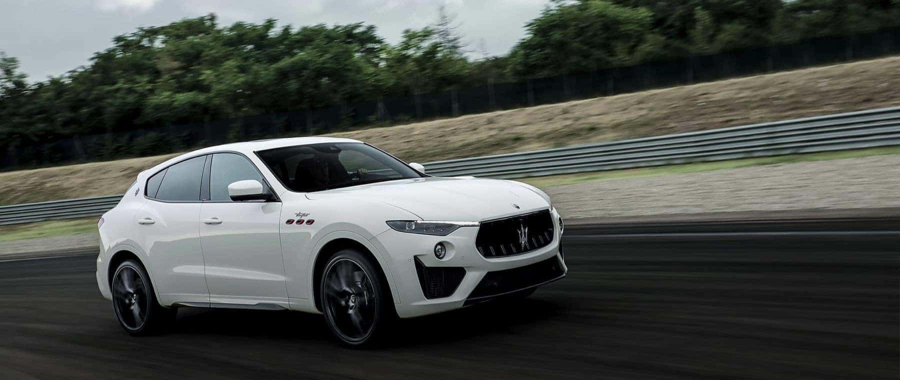 white maserati car driving in the road