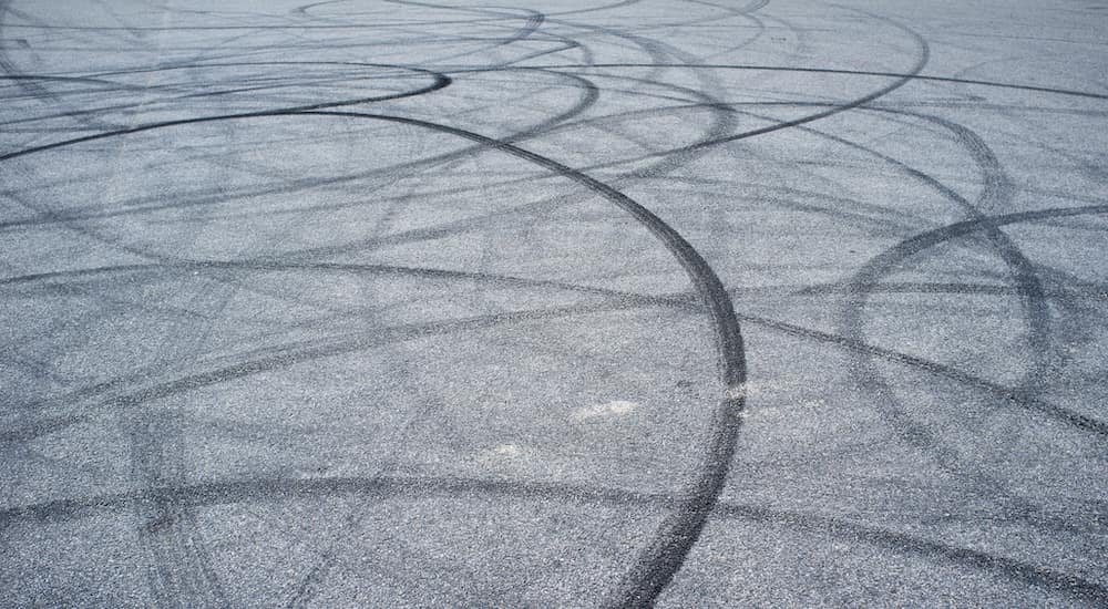 Tire skid marks are shown on a road.