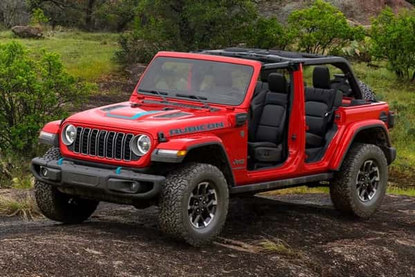 2025-Jeep-Wrangler-4xe-parked-on-a-dirt-hill-in-a-forest