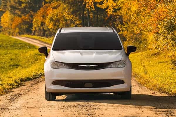 2026-Chrysler-Voyager-parked-in-a-field-on-a-dirt-road