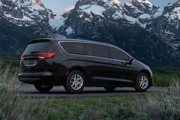 2026-Chrysler-Voyager-parked-in-a-field-with-snowy-mountains-in-the-background