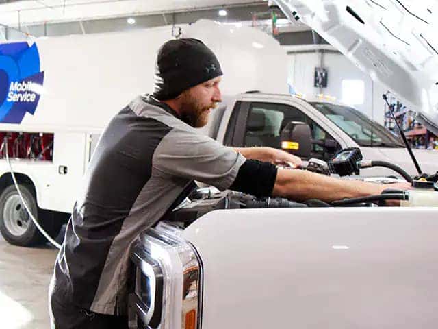 Mobile Service technician working on a vehicle