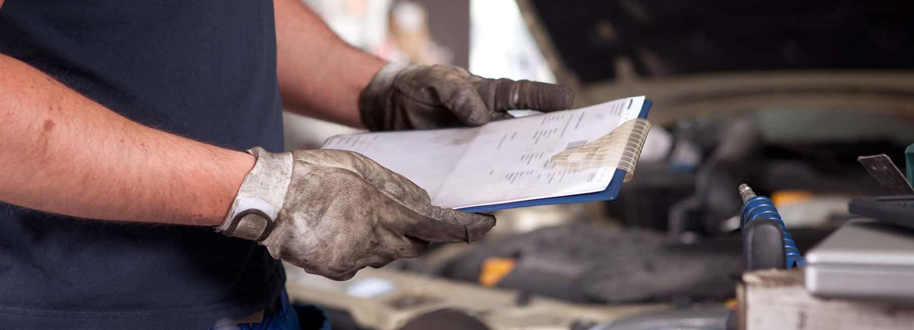 Mechanic holding a Vehicle Inspection Checklist