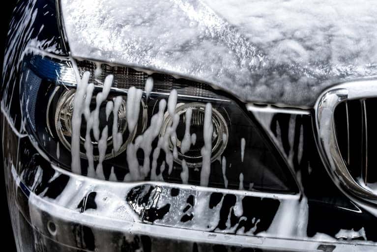 Close up of a car headlight being washed
