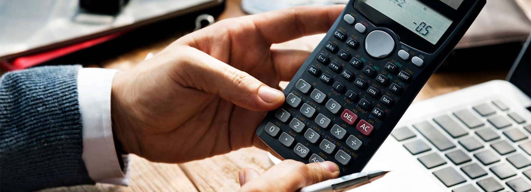 Hands Holding a Calculator