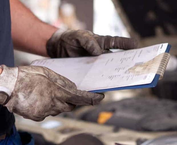 Mechanic with Vehicle Inspection Checklist