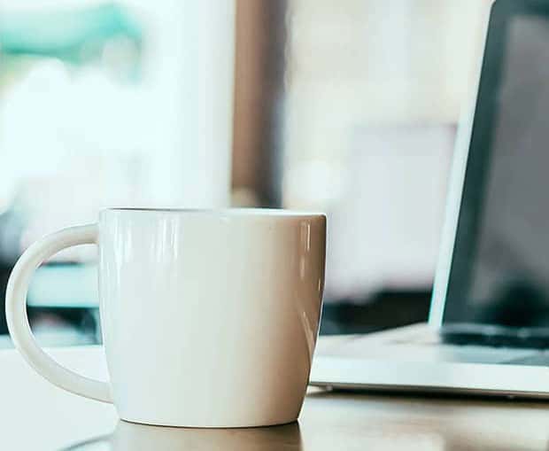 Coffee Cup In Front Of Computer