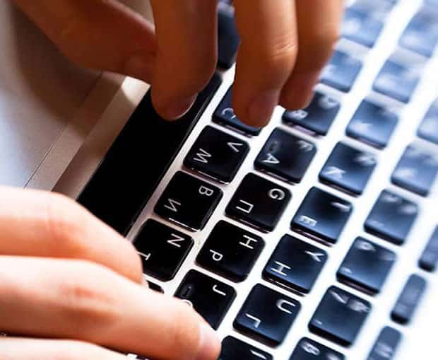 Hands typing on keyboard