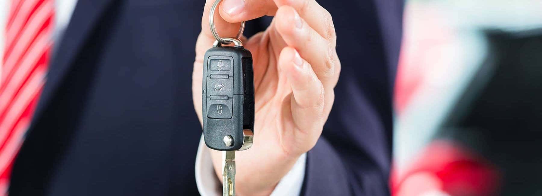 Person in Suit Holding Car Keys