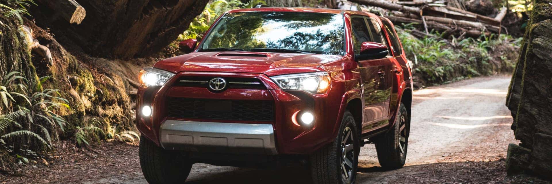 2024-Toyota-4Runner-driving-on-narrow-dirt-road-through-a-lush-forest