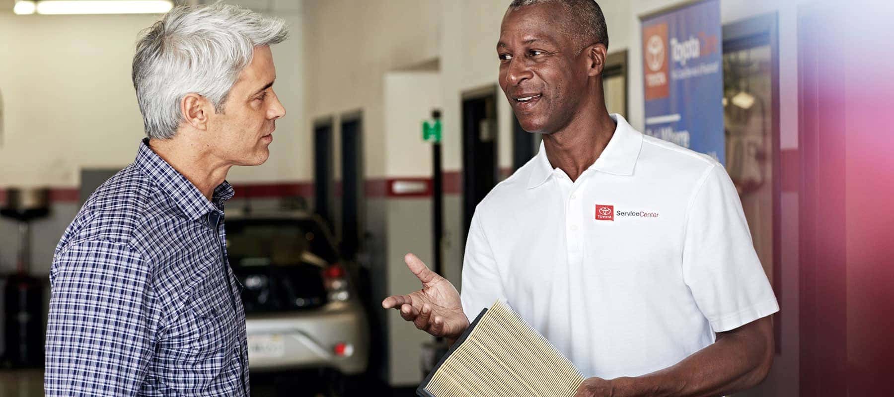 Toyota-service-technician-talking-with-a-man