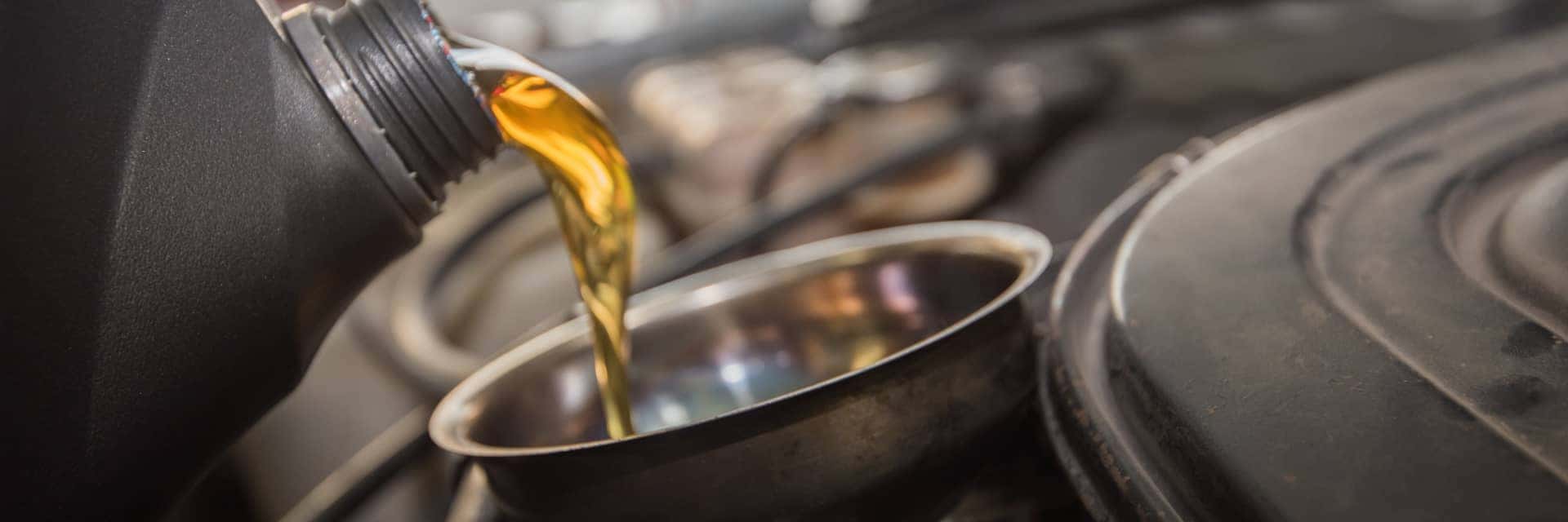 pouring fresh oil into funnel