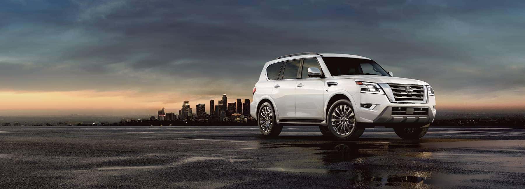 A 2021 White Nissan Armada parked at duck in front of a city skyline