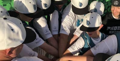 Baseball team gathering in huddle
