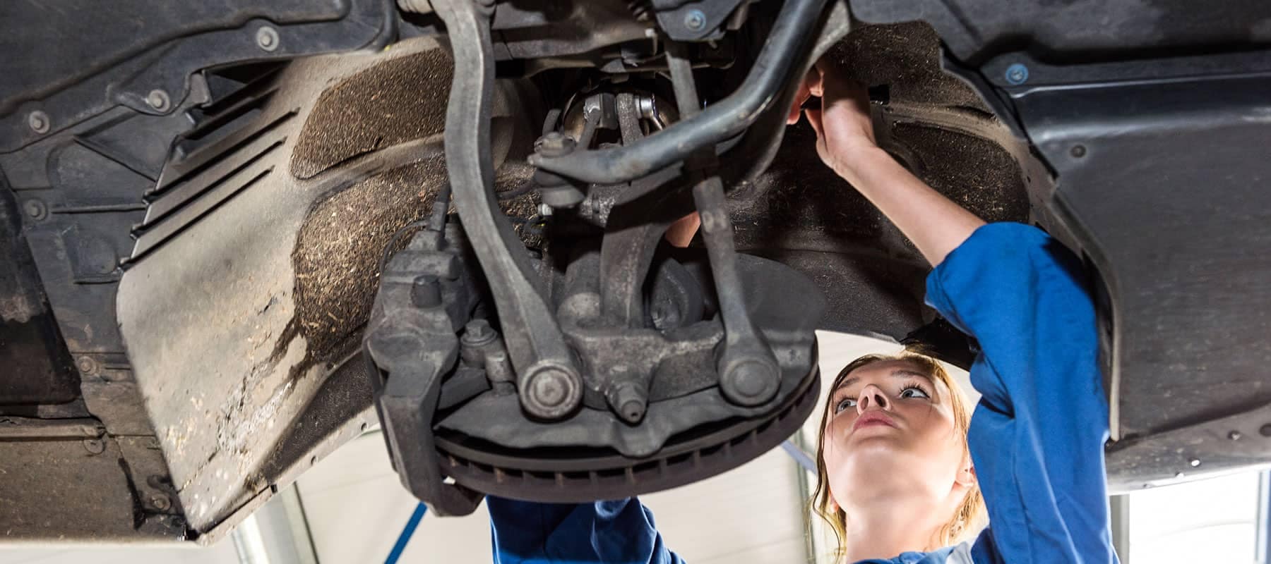 picture of service technician working on car brakes