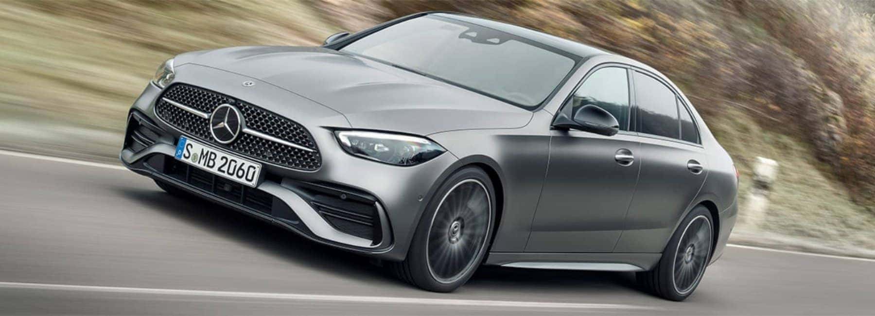 2022c-class_sedan-side-3qview-driving-angles-shot-grey
