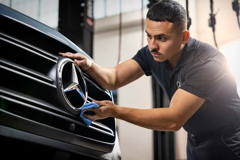 Mercedes-Benz-service-technicial-shining-the-hood-ornament