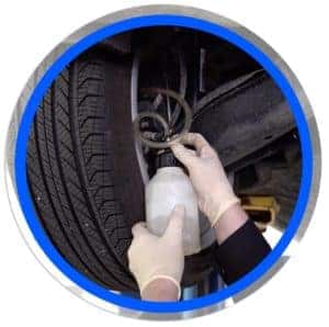 technician flushing brakes