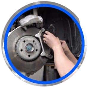 technician replacing brake pad