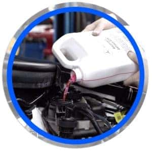 technician topping off fluid