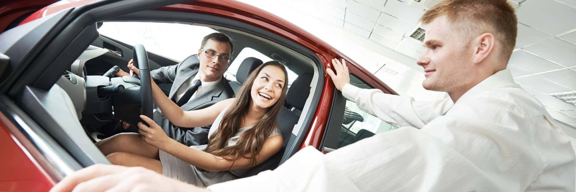 couple-looking-at-a-new-vehicle-with-finance-specialist