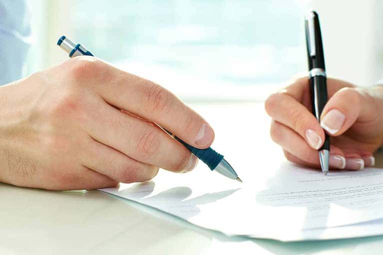 People writing on paper