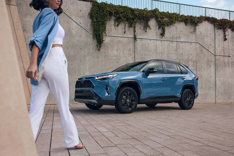 Woman walking toward a Toyota SUV