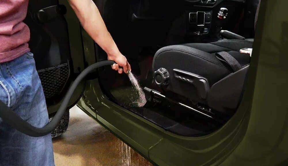Green Jeep Wrangler SUV Hose Man Water Black Seats