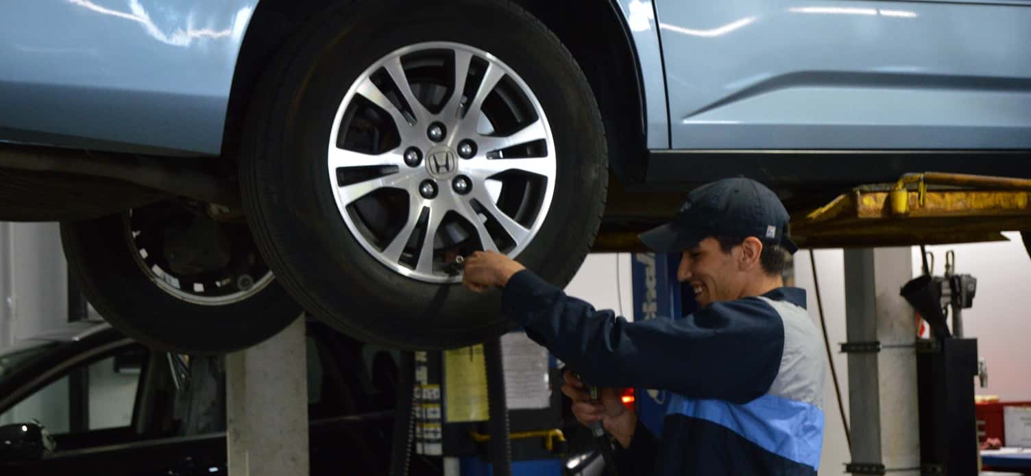 Man Working on a Honda Tire
