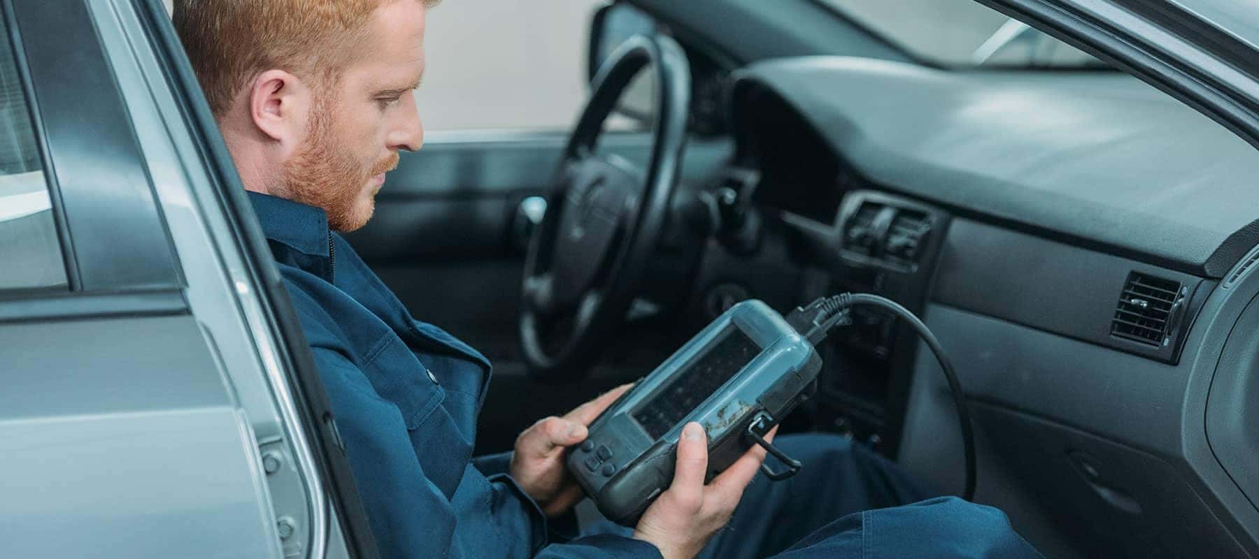 Diagnostic picture of technician looking up car readings