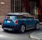 blue MINI turning on road - small