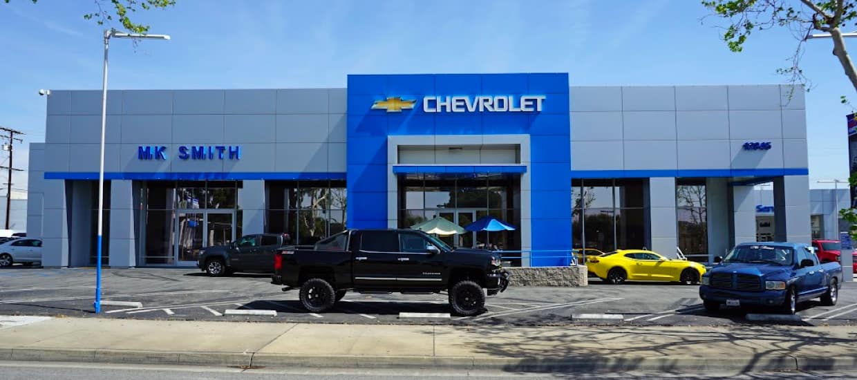 An exterior shot of a Chevrolet dealership at daytime.