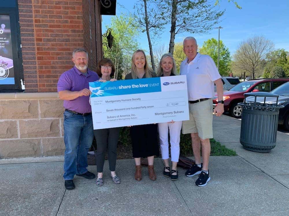 Holding a check for charity