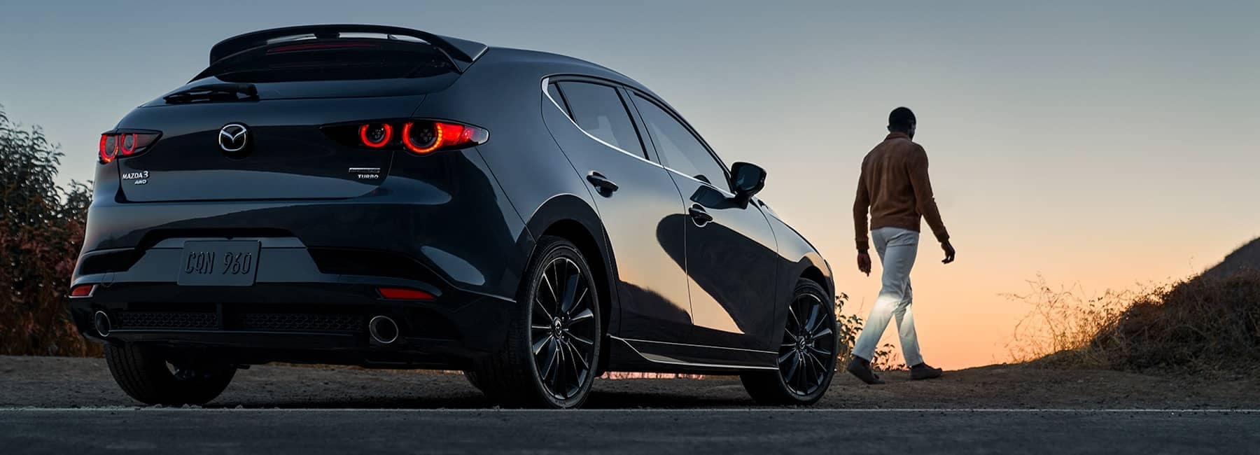 2022 Mazda 3 hatchback back view with sunset