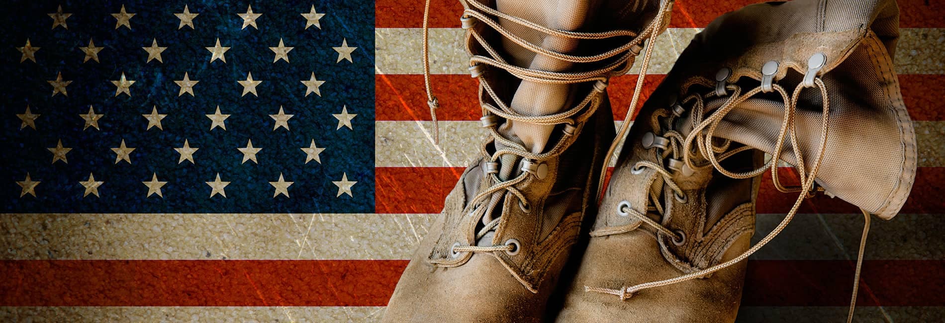 Military style boots on top of an American flag background