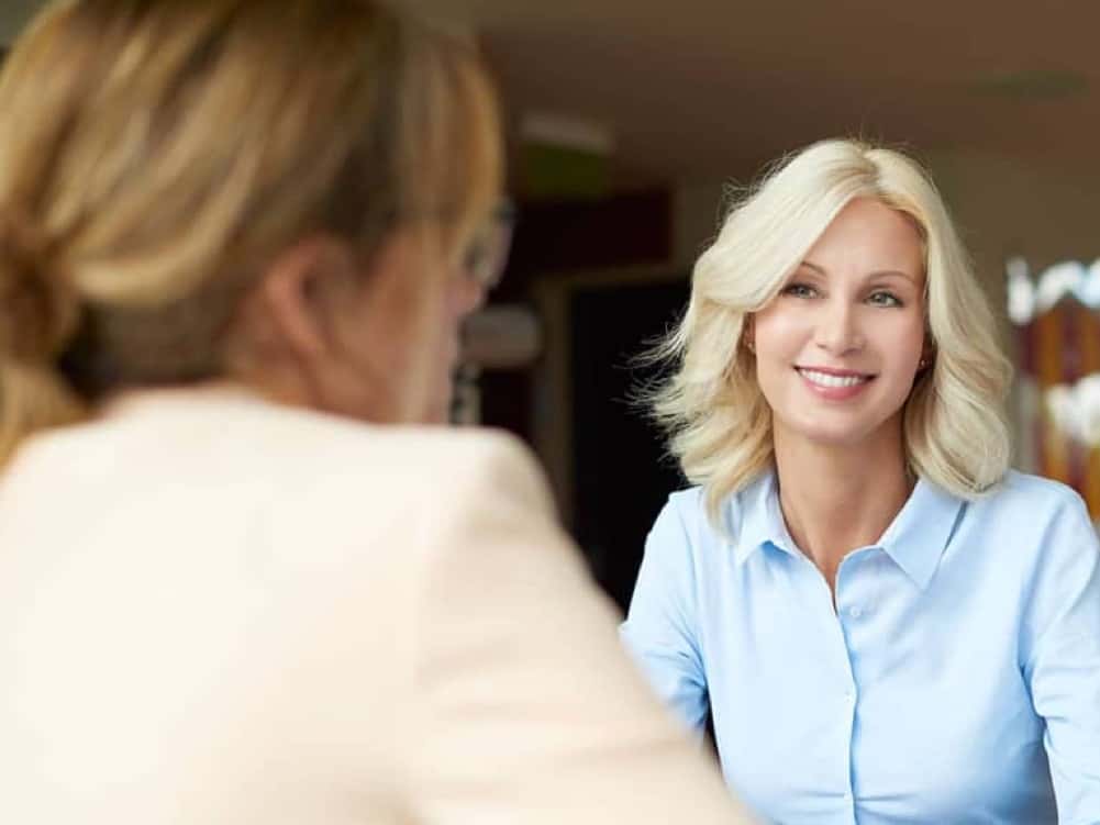 woman is talking with saleswoman