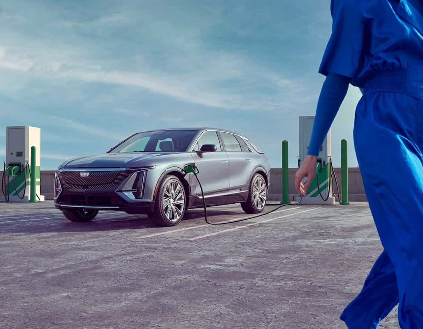 Cadillac EV plugged into charging station