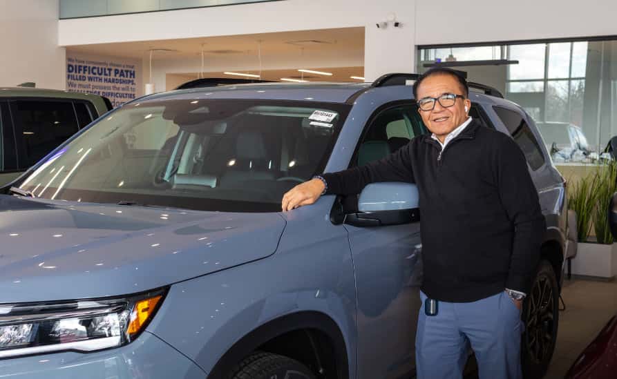 Sales leaning on vehicle