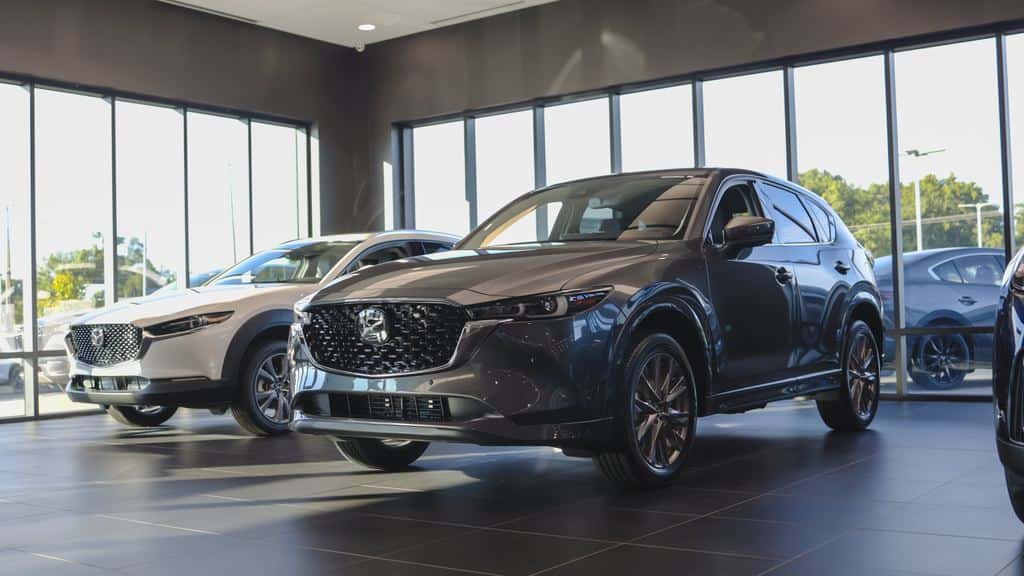 New Mazda CX-5 and CX-50 SUVs on a dealership showroom floor