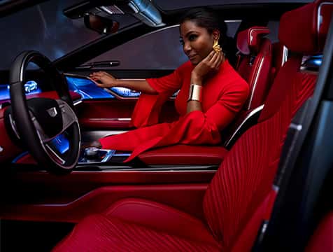 Woman sitting in a Cadillac