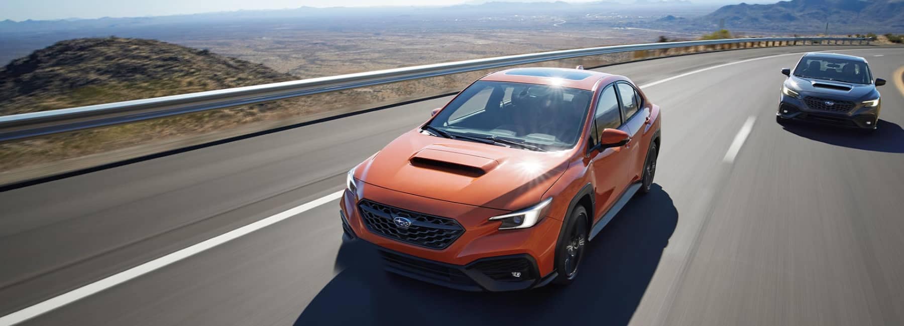 2022 Subaru WRX front view-2 cars on highway