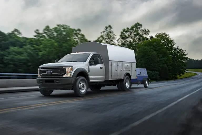 2021 Ford Chassis Cab pulling a trailer down a freeway