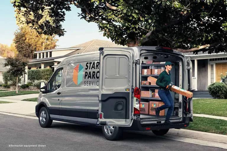 2021 Ford Transit with delivery person taking packages out the back