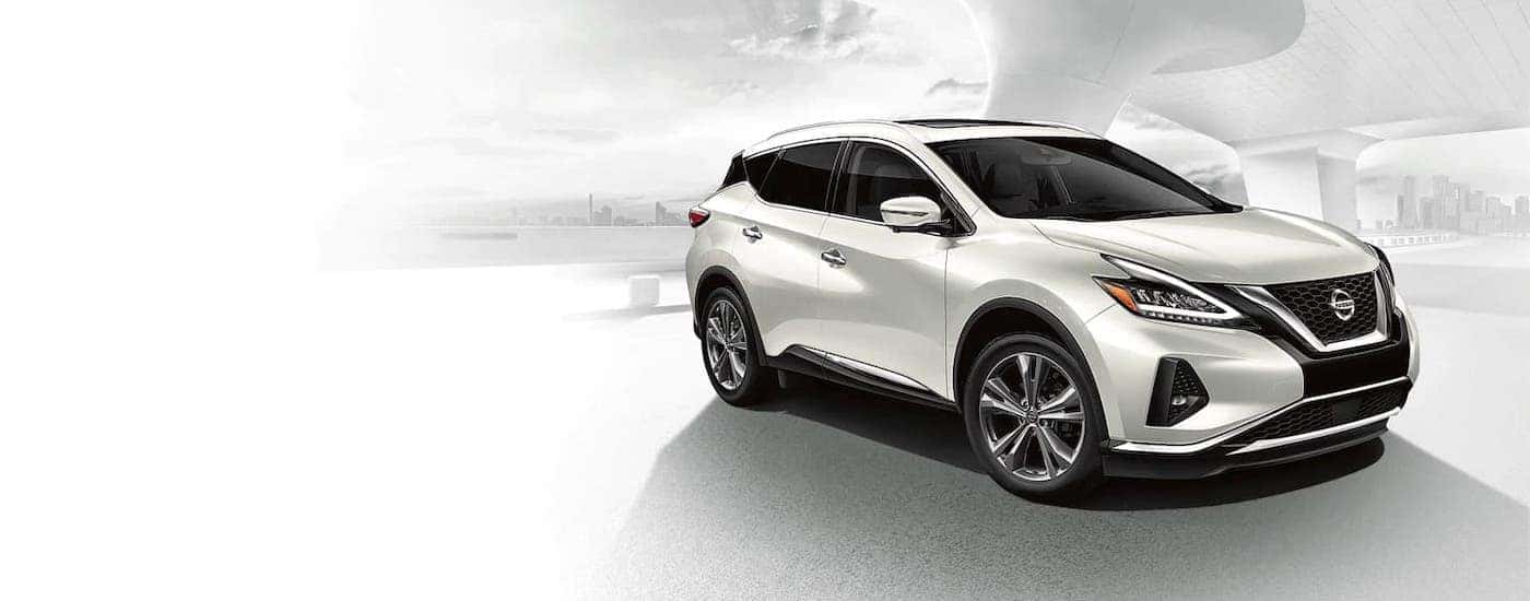 A white 2021 Nissan Murano from a Mount Juliet Nissan dealer is shown in front of a white building.