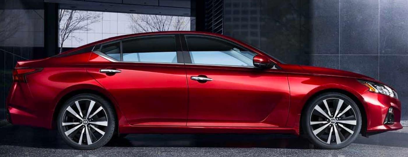 A red 2019 Nissan Altima is facing right.