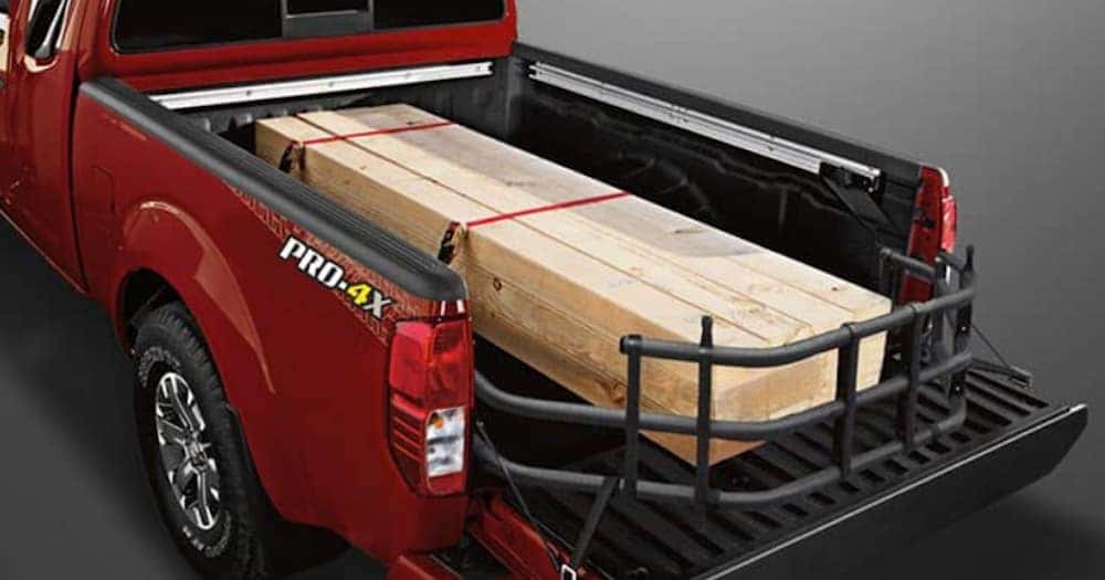 Wood is in the bed of a red 2020 Nissan Frontier.
