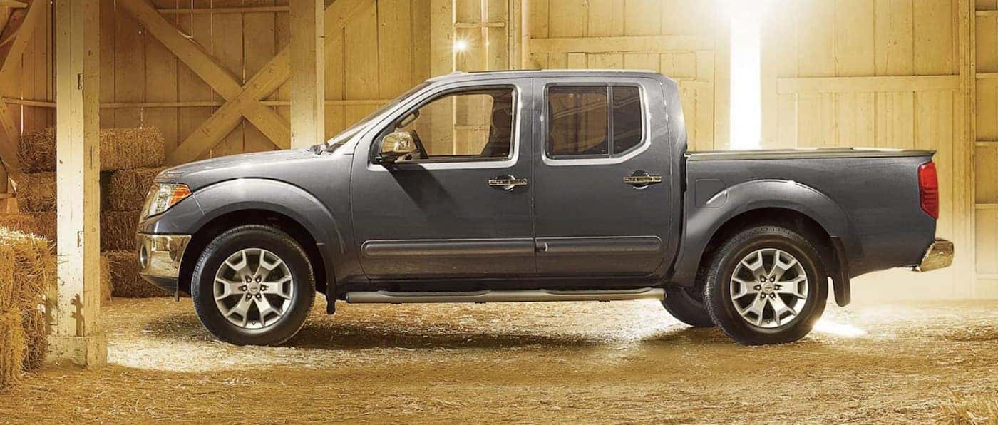 A grey 2020 Nissan Frontier is in a barn.