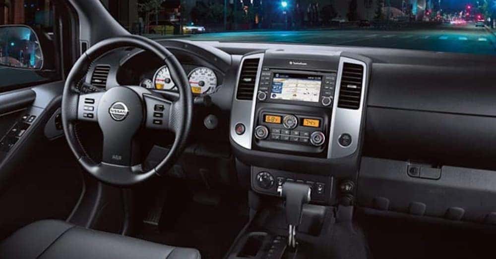 The black interior of a 2020 Nissan Frontier is shown.