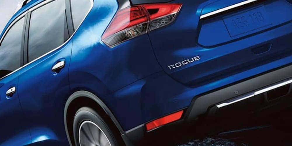 A blue 2020 Nissan Rogue is shown from the rear in closeup.