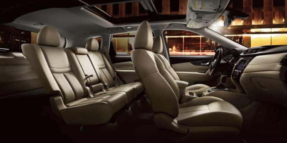 The tan interior in a 2020 Nissan Rogue is shown from the side.